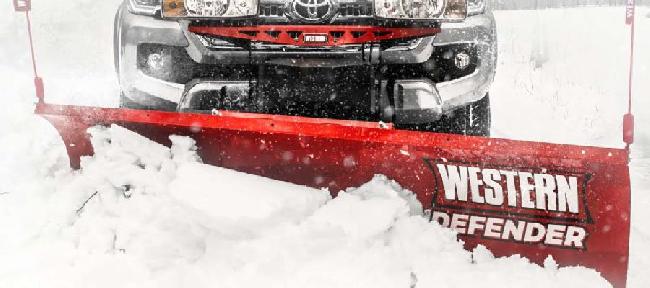 Western Snow Plow available at Markham Mower clearing a road